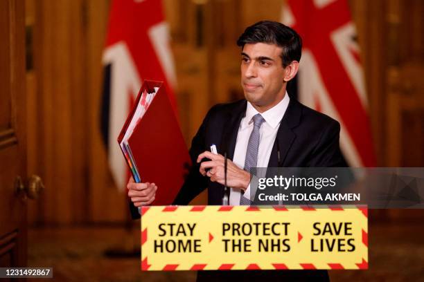 Britain's Chancellor of the Exchequer Rishi Sunak attends a virtual press conference inside 10 Downing Street in central London on March 3 following...