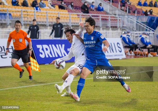 Kim Hyo-Gi of Gwangju FC and Min Sang-Gi of Suwon Samsung Bluewings FC are seen in action during the 1st round of the 2021 K League match between...