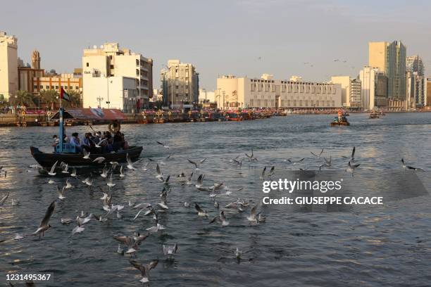 Boats sail along the Dubai creek in the old neighbourhood of Deira, in the Gulf Emirate, on March 3, 2021.