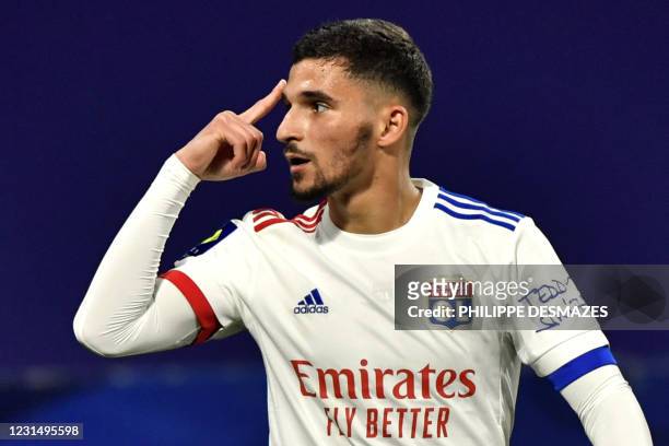 Lyon's French midfielder Houssem Aouar celebrates after scoring during the French L1 football match between Olympique Lyonnais and Stade Rennais...