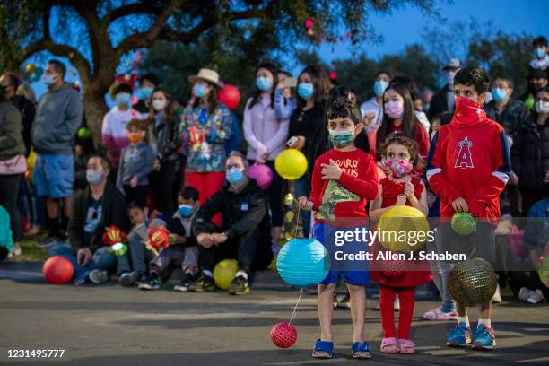 February 26: People hold lanterns as fellow neighbors of an Asian-American family that was harassed and community members put on a Lantern Festival...