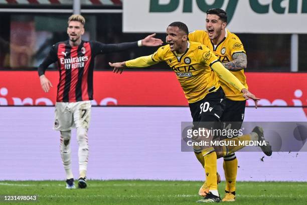 Udinese's Brazilian defender Rodrigo celebrates after opening the scoring during the Italian Serie A football match AC Milan vs Udinese on March 03,...