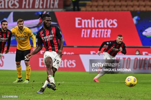 Milan's Ivorian midfielder Franck Kessie shoots to score a last minute penalty during the Italian Serie A football match AC Milan vs Udinese on March...