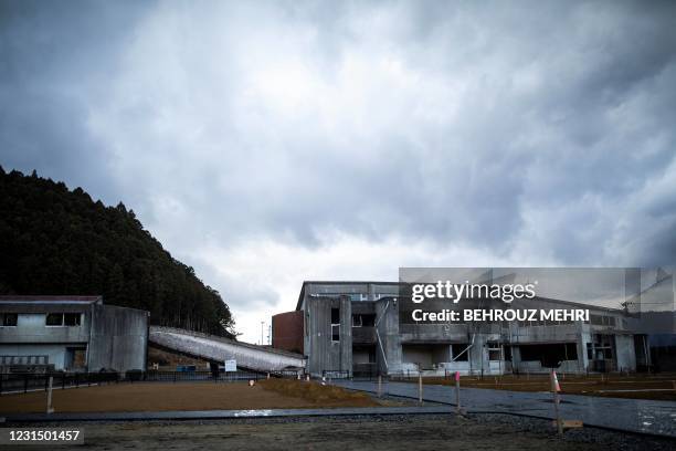 This picture taken on February 7, 2021 shows the damaged Okawa elementary school, where 74 schoolchildren and 10 staff were killed in the Japan's...