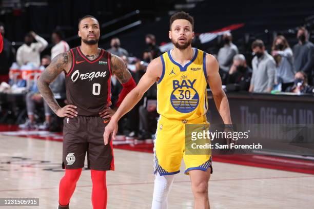 Damian Lillard of the Portland Trail Blazers and Stephen Curry of the Golden State Warriors look on during the game on March 3, 2021 at the Moda...