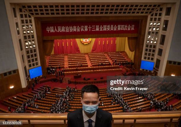 Security officer wears a protective mask as delegates leave the opening session of the Chinese People's Political Consultative Conference at the...