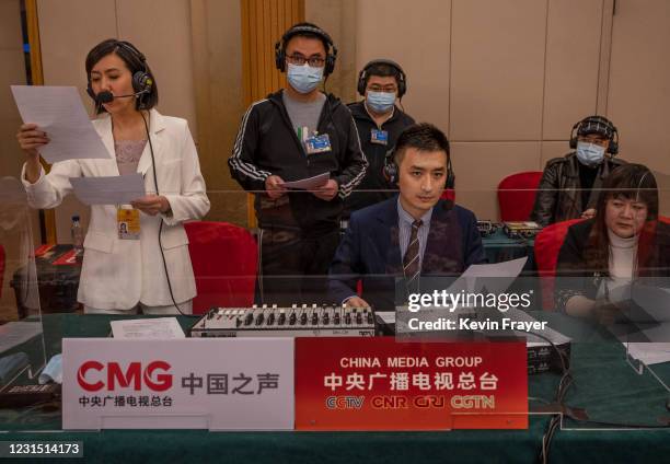 Journalist from Chinese media broadcast the National People's Congress Spokesperson Zhang Yesui's video news conference, as a precaution for COVID-19...