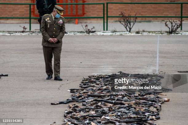 Member of the army looks at weapons destroyed during a ceremony for the destruction of weapons seized in police operations against ETA and GRAPO...