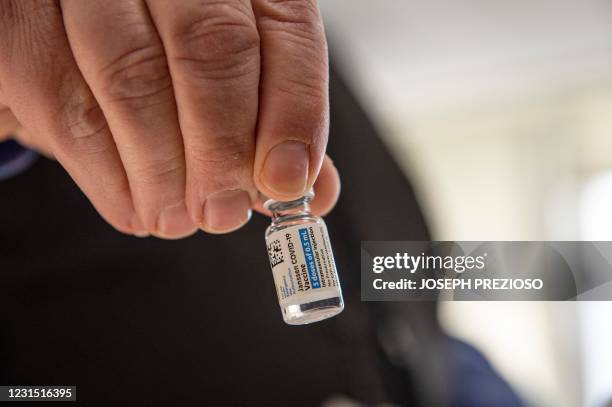 Pharmacist Antoun Houranieh holds a vial of the Johnson & Johnson Covid-19 Janssen Vaccine at the US Department of Veterans Affairs' VA Boston...