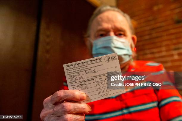 Gerald McDavitt a Veteran of the United States Army Corps of Engineers, holds his CDC vaccine card after being inoculated with the Johnson & Johnson...