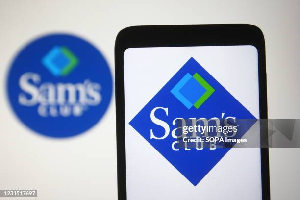 In this photo illustration a Sam's Club logo of a US chain of membership-only retail warehouse clubs is seen on a smartphone and a pc screen.