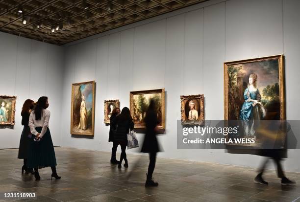 People look paintings during the Frick Collection opening press preview at Frick Madison in the Marcel Breuer building on March 4, 2021 in New York...