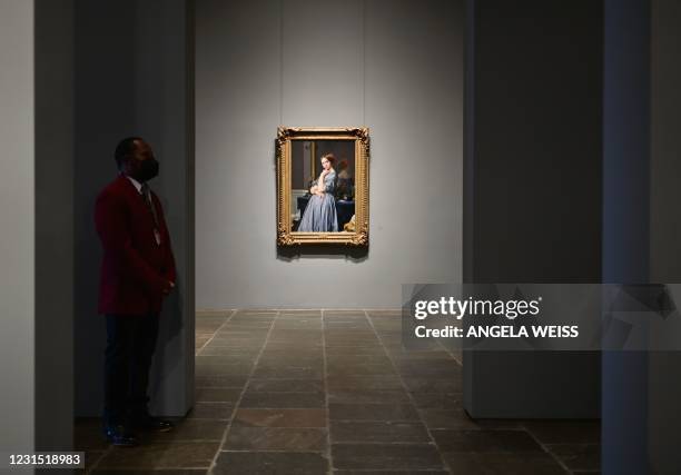 Security guard stands near the painting "Comtesse d'Haussonville" by Jean-Auguste-Dominique Ingres during the Frick Collection opening press preview...