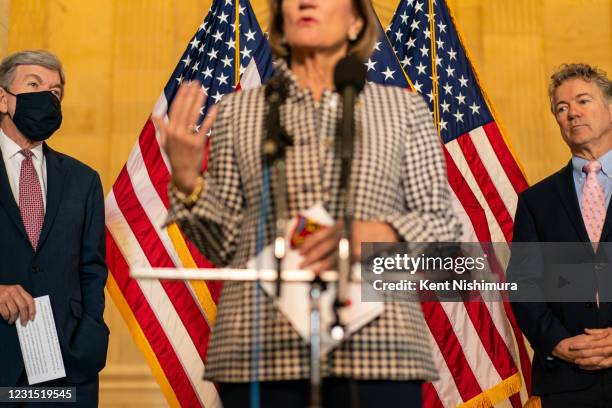 Sen. Roy Blunt and Sen. Rand Paul stand at a press conference while Sen. Shelley Moore Capito speaks during a press conference on Capitol Hill on...