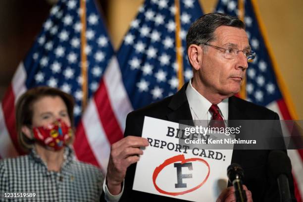 Sen. John Barrasso holds a sign while speaking at a press conference on Capitol Hill on Thursday, March 4, 2021 in Washington, DC.