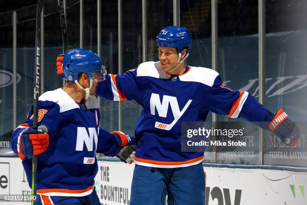 Matt Martin of the New York Islanders is congratulated by Cal Clutterbuck after scoring a goal against the Buffalo Sabres during the first period at...