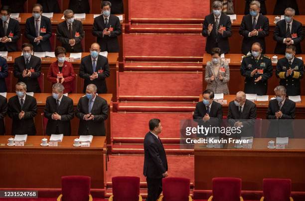 President Xi Jinping is applauded by members of the government, including Hong Kong Chief Executive Carrie Lam, right middle row, as he arrives at...