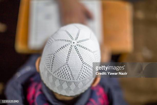 Kashmir Muslim boy learns recitation of the Quran in a Darsgah or Madrassa, a local Islamic seminary on March 04, 2021 in Srinagar, the summer...