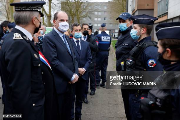 French Prime Minister Jean Castex flanked by French Interior Minister Gerald Darmanin and MP Olivier Dassault meet police officers during a visit...