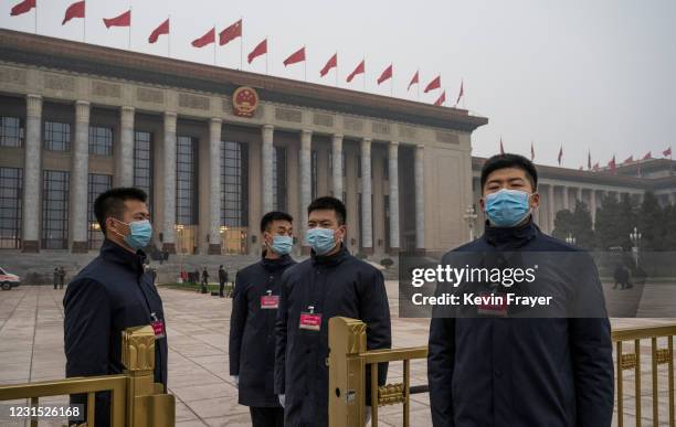 Security stand at a gate where Chinese and foreign journalists are checked prior to entering the opening session of the National People's Congress at...