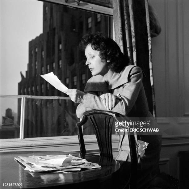 French singer Edith Piaf poses in New York, reading, in September 1946.