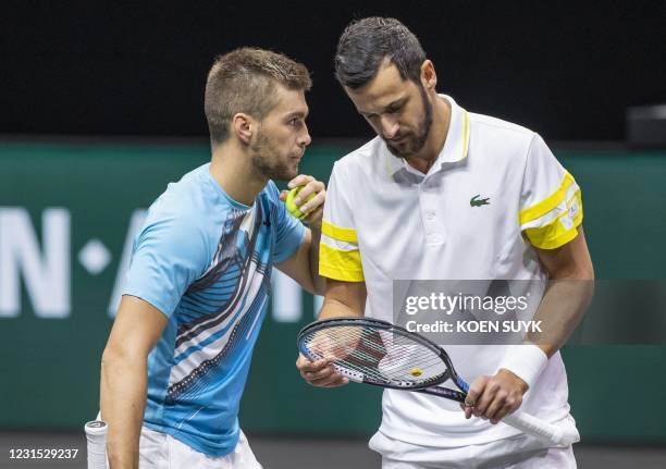 Croatian nationals Mate Pavic and team mate Nicola Mektic discuss during their match against France's Pierre Hugues Herbert and Germany's Jan Lennard...