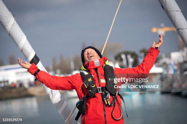 Finnish skipper Ari Huusela celebrates after crossing the finish line in 25th and last position of the Vendee Globe round-the-world solo sailing race...