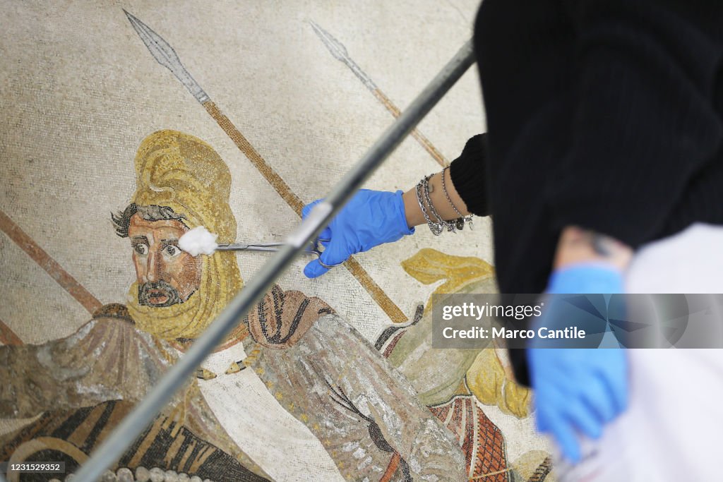 A restorer working on the Pompeian mosaic, known as