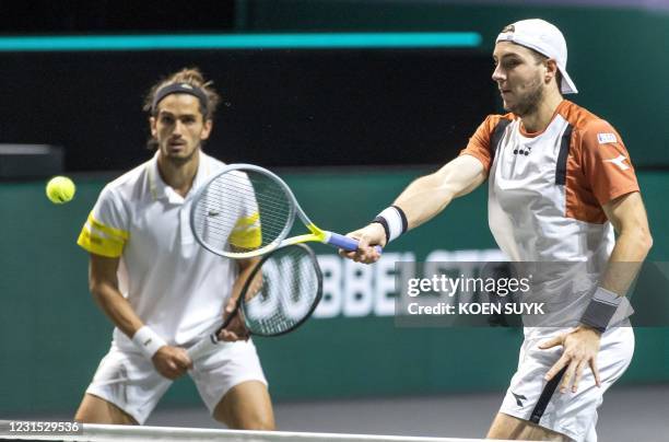 France's Pierre Hugues Herbert and Germany's Jan Lennard Struff return the ball during their doubles match against Croatia's Nicola Mektic and team...