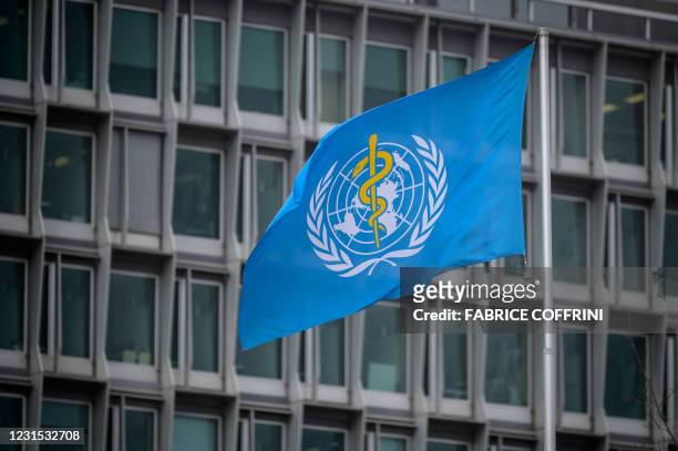 This photograph taken on March 5, 2021 shows the flag of the World Health Organization at their headquarters in Geneva amid the Covid-19 coronavirus...