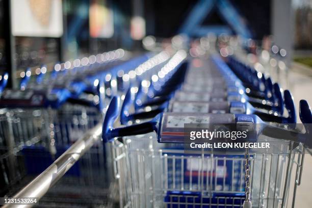 Shopping carts are seen at a ALDI Nord store in Luenen, western Germany, on March 5, 2021. - The German discounter Aldi starts to sell Corona rapid...