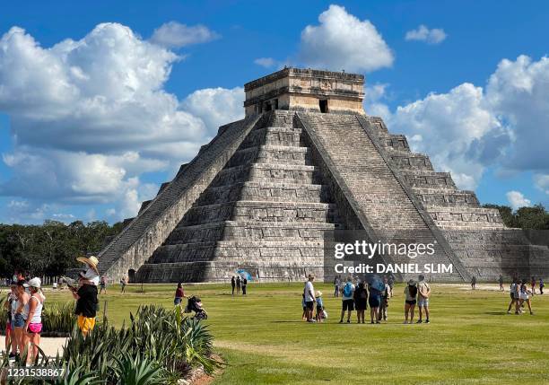 Tourists wearing face masks are seen at Chichen Itza archaeological site in Mexico on March 5, 2021. - Pre-Hispanic City Chichen Itza is a symbol of...