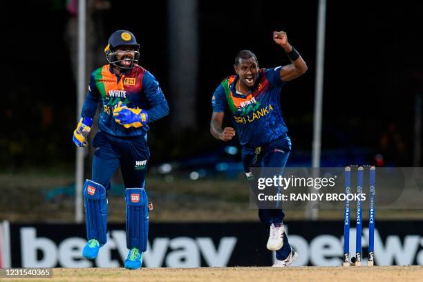 Niroshan Dickwella and Angelo Mathews of Sri Lanka celebrate the dismissal of Chris Gayle of West Indies during the 2nd T20i match between Sri Lanka...