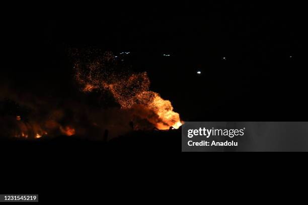 Firefighters extinguish a fire in al-Bab district after ballistic missiles targeted two separate areas in Aleppo, northern Syria, on March 06, 2021....