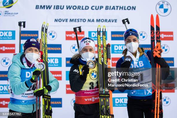 Second place athlete Yuliia Dzhima of Ukraine, race winner Tiril Eckhoff of Norway and third place athlete Lisa Vittozzi of Italy celebrate during...