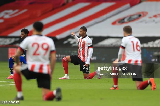 Sheffield United's English striker Rhian Brewster joins other players in taking a knee against racism ahead of kick off of the English Premier League...