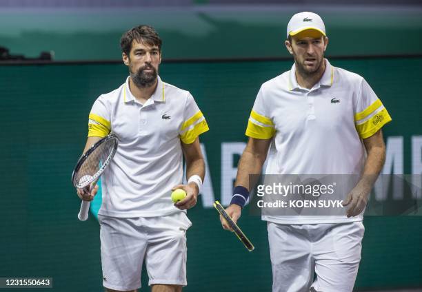 France's Jeremy Chardy and Fabrice Martin are seen during their Rotterdam ATP tournament men's double semi-final tennis match against Croatia's...