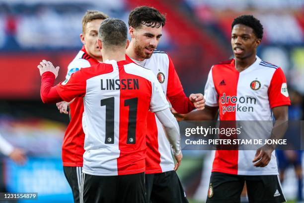 Feyenoord's Jens Toornstra, Orkun Kokcu, Bryan Linssen, and Tyrell Malacia celebrate their team's third goal during the Dutch Eredivisie football...