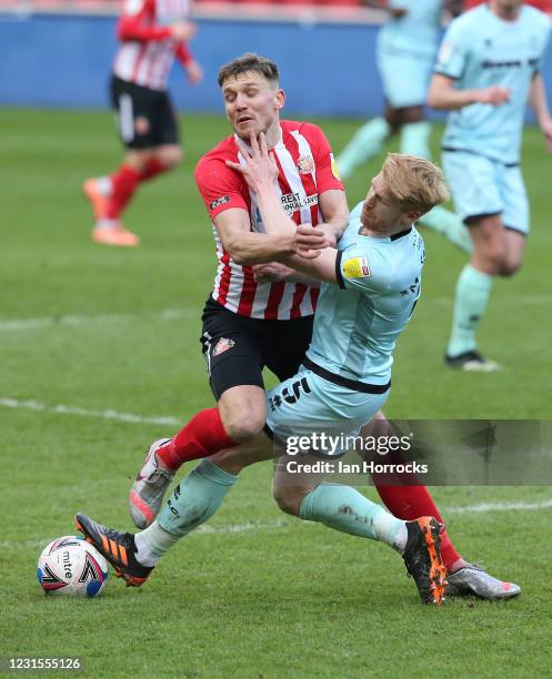 Charlie Wyke of Sunderland is tackled by Paul McShane of Rochdale during the Sky Bet League One match between Sunderland and Rochdale at Stadium of...