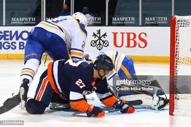 Anders Lee of the New York Islanders scores a goal past Carter Hutton of the Buffalo Sabres during the third period at Nassau Coliseum on March 06,...