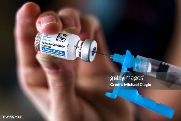 Adams 12 Five Star Schools District RN Tiffany Karschamroon draws a dose from a vial of the Johnson & Johnson COVID-19 vaccine, the newest vaccine...