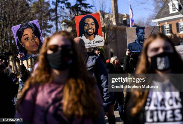 People hold portraits of Breonna Taylor, Philando Castile, and Elijah McClain during a protest demonstration outside the Governors Mansion on March...