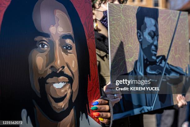 Two women hold placards with the images of Philando Castile and Elijah McClain outside of Minnesota Governor's residence during the protest "Families...