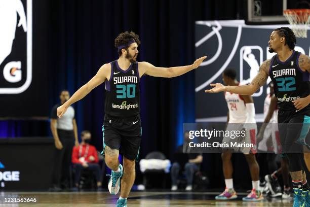 Nate Darling high-fives KJ McDaniels of the Greensboro Swarm during the game on March 6, 2021 at HP Field House in Orlando, Florida. NOTE TO USER:...