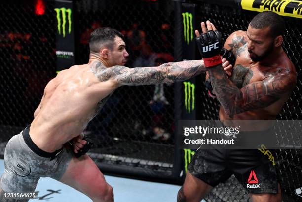 In this handout image provided by UFC, Aleksandar Rakic of Austria punches Thiago Santos of Brazil in their light heavyweight fight during the UFC...