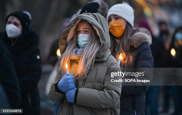 Friends and family of victims holding burning candles, during the event. A memorial and vigil for victims of Covid19 was held outside of the Luzerne...