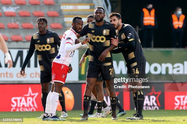 Mouscron, Belgium Fabrice Olinga forward of Mouscron with Konstantinos Laifis defender of Standard Liege and Merveille Bope Bokadi midfielder of...