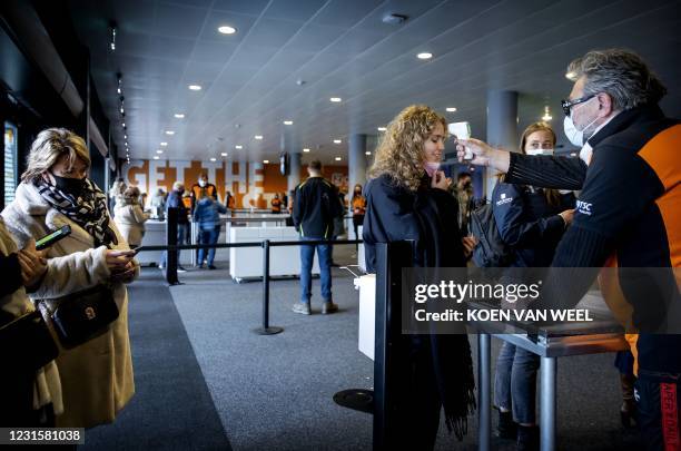 Visitors have their temperature measured upon arrival prior to a trial event at the Ziggo Dome part of a series of trial events in which Fieldlab is...