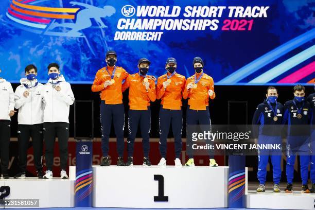 Team Netherlands celebrates gold on the podium after winning the 5000 meters men's relay on the last day of the ISU World Short Track Speed Skating...