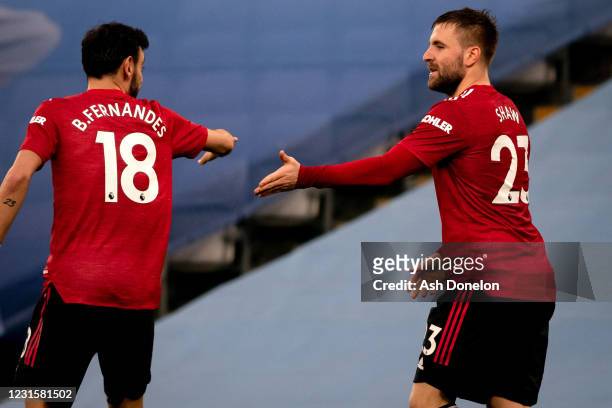 Luke Shaw of Manchester United celebrates scoring a goal to make the score 0-2 with Bruno Fernandes during the Premier League match between...